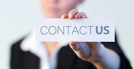 A contact us card in a woman's hand.