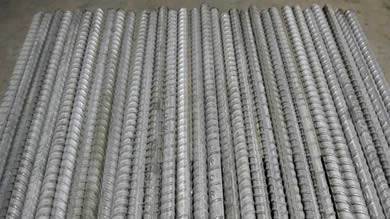 some straight deformed galvanized rebars lying on the wooden board