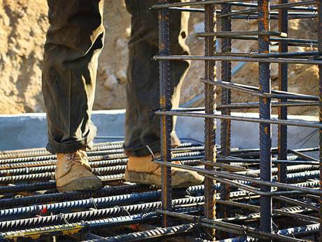 A worker who is operating on high wears a pair of flat and anti-skid shoes.